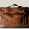Brown leather shoulder bag with zip opening on white background