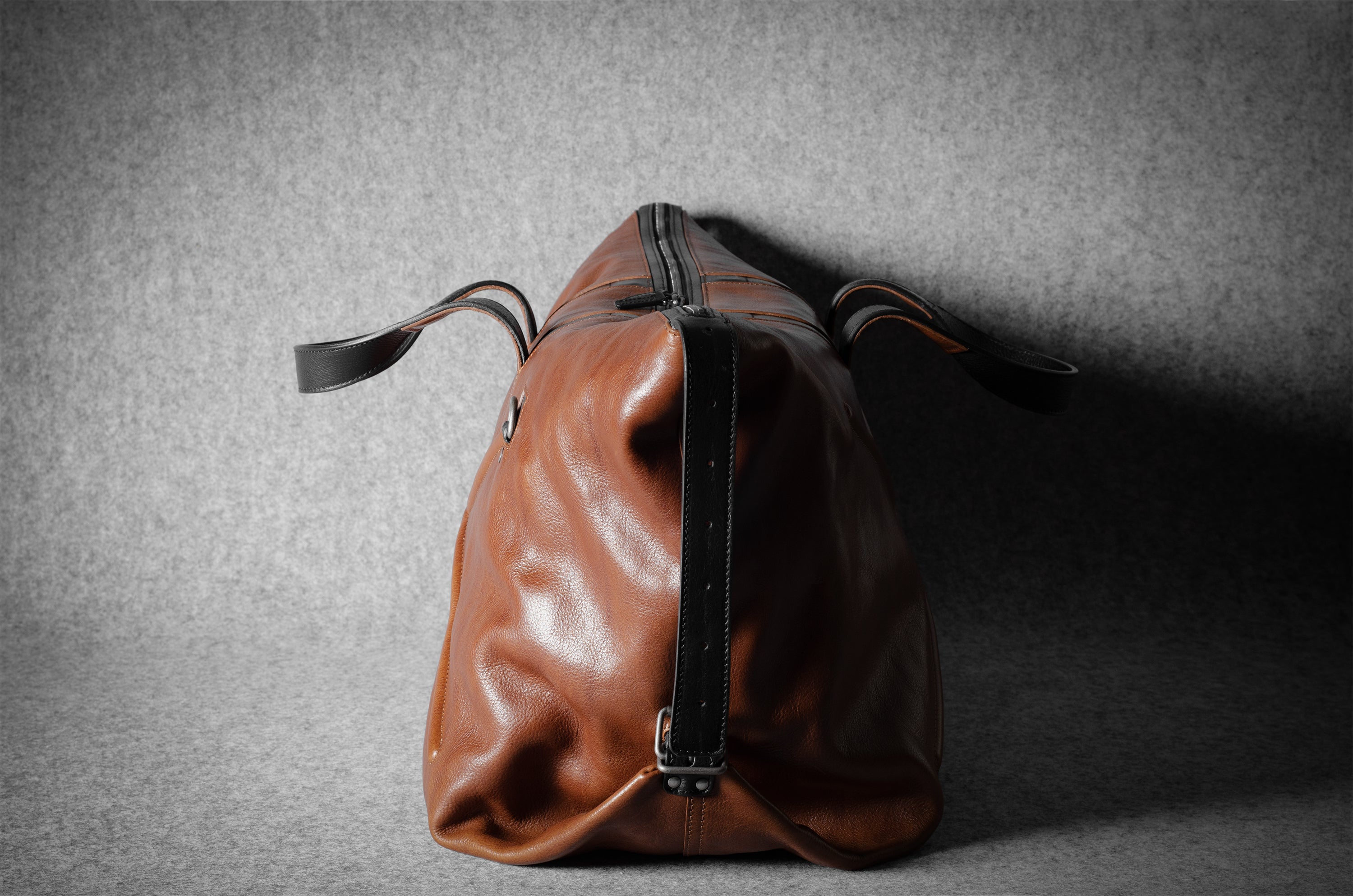 Brown leather bag on a gray textured background