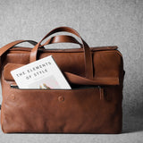 Brown leather briefcase bag on a gray background