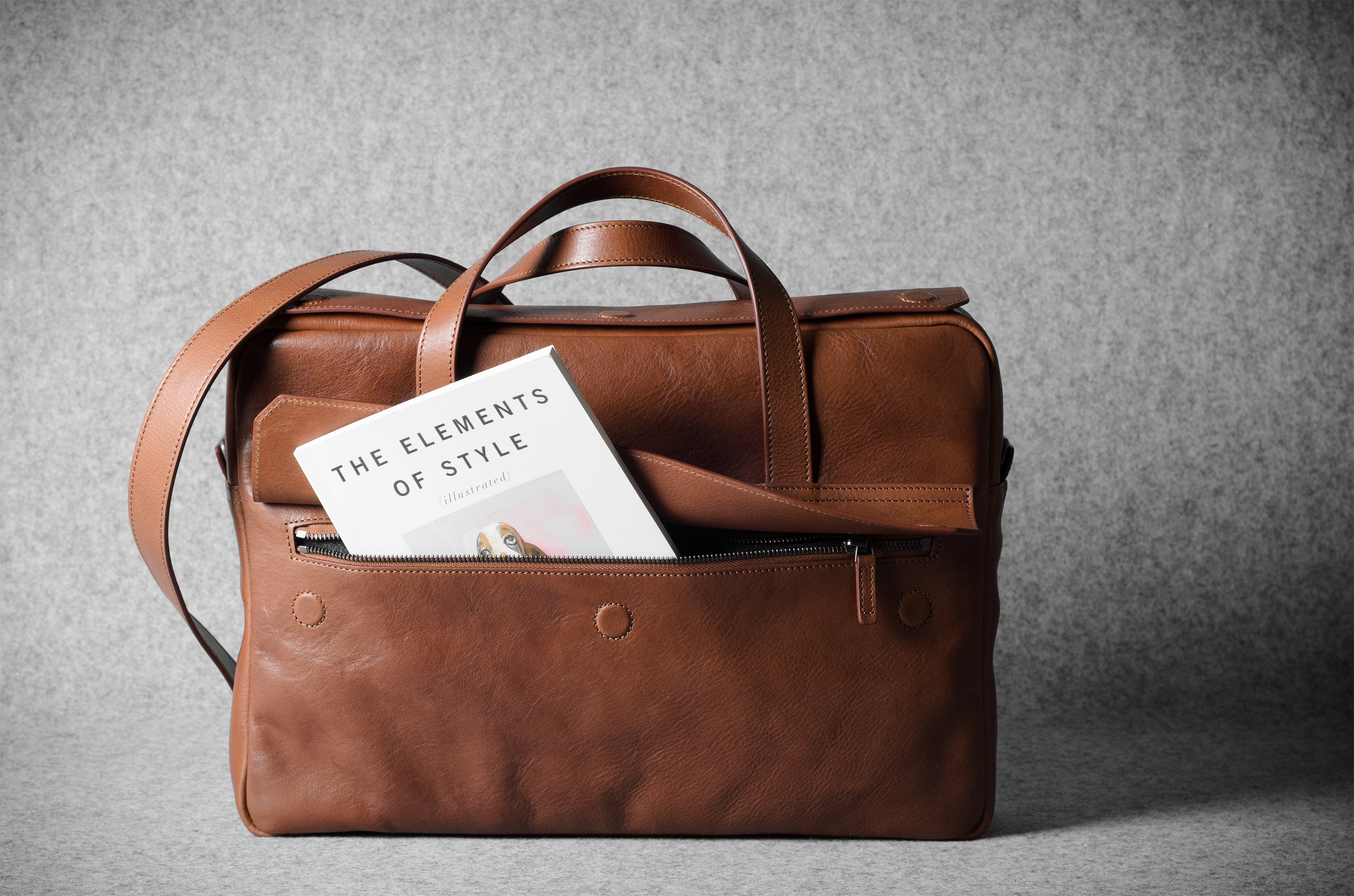 Brown leather briefcase bag on a gray background