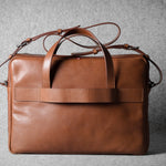 Brown leather briefcase bag on a gray background