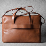 Brown leather briefcase bag on a gray background