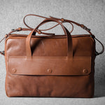 Brown leather briefcase bag on a gray background