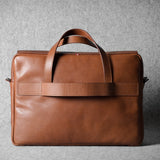 Brown leather briefcase bag on a gray background