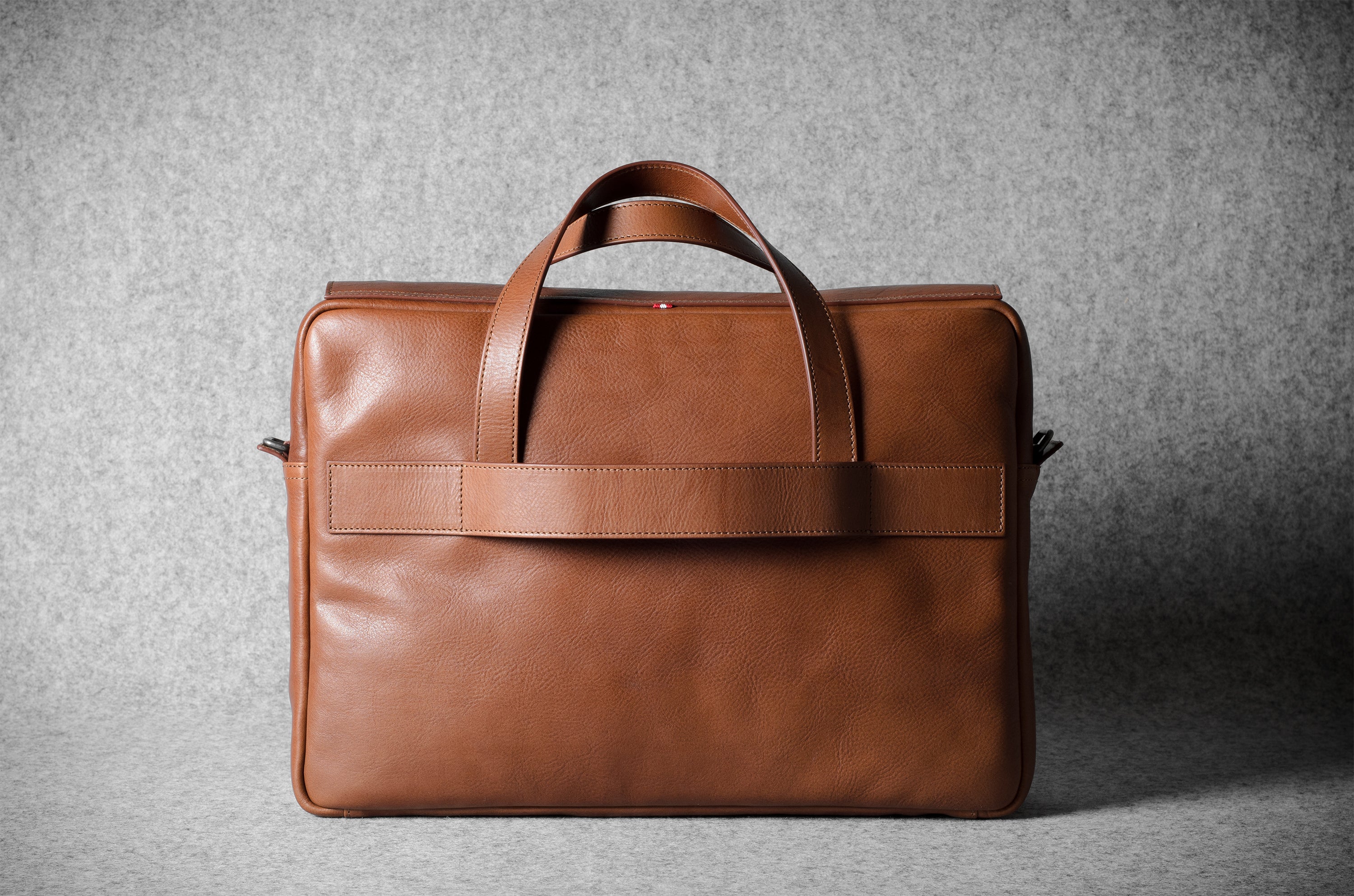 Brown leather briefcase bag on a gray background