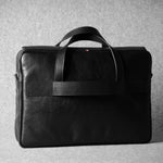 Black leather briefcase bag on a gray background