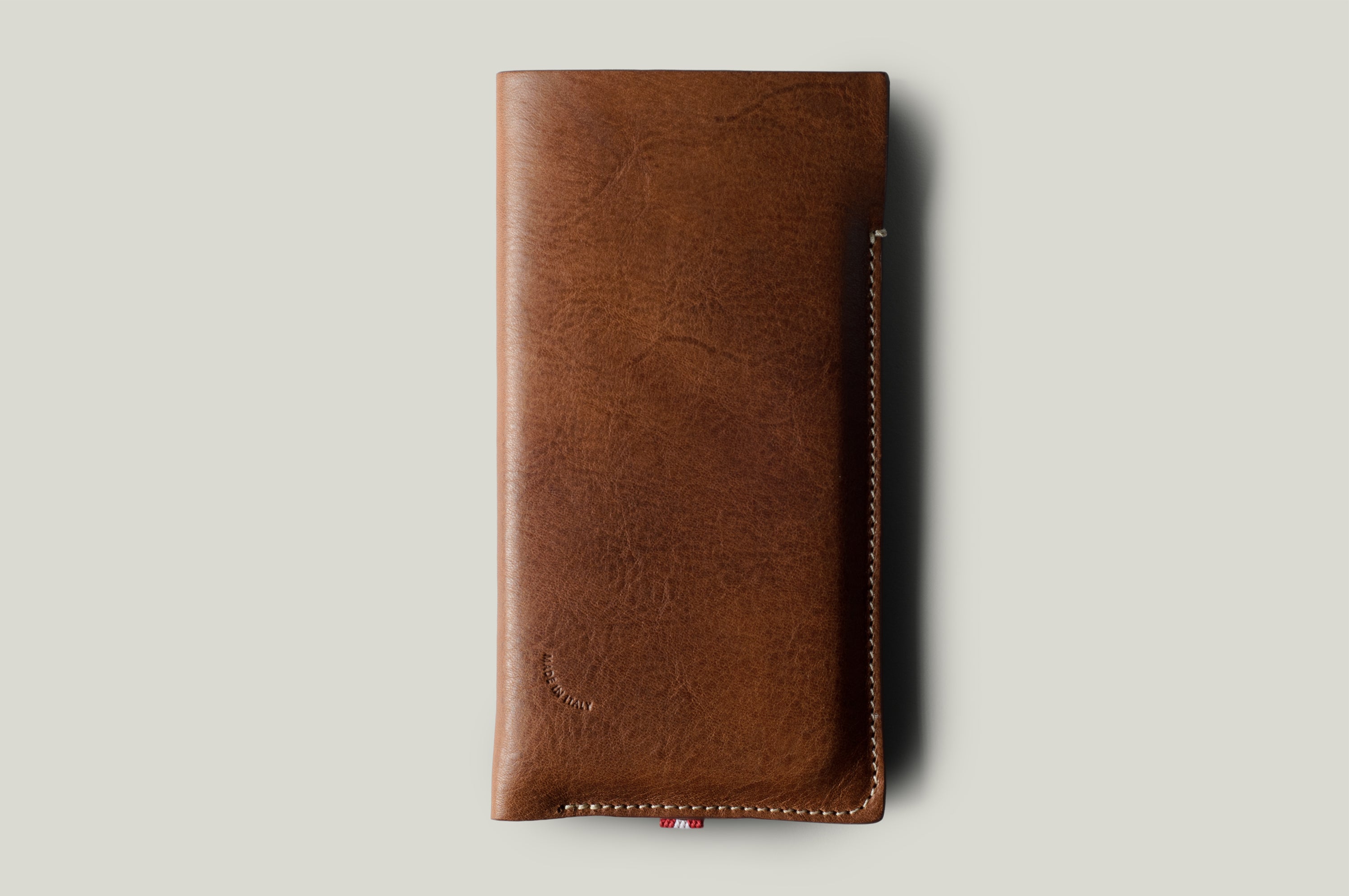 Brown leather phone case on a light gray background