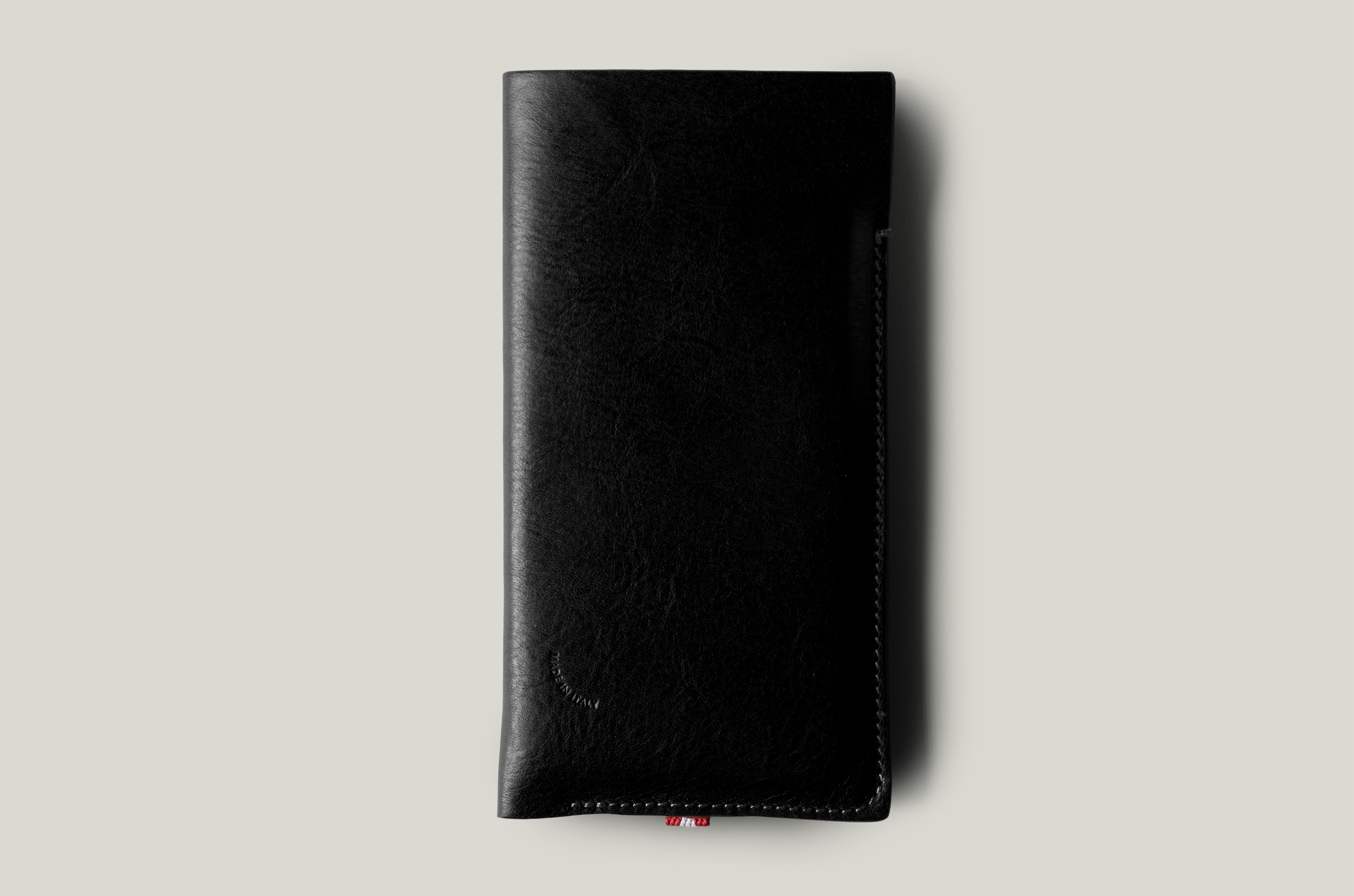 Black leather iphone case on a light gray background