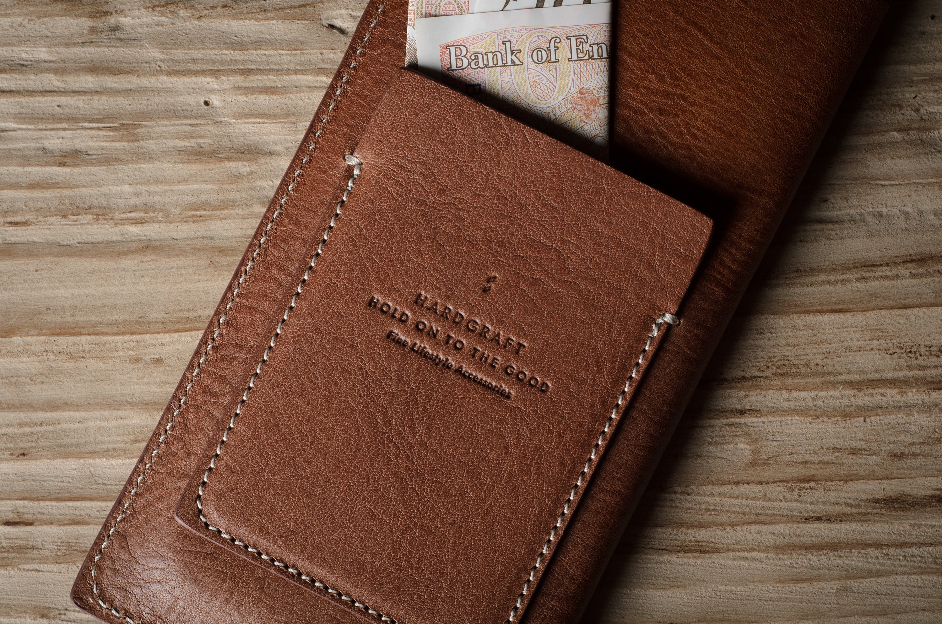 Brown leather  iphone case with visible branding on a wooden surface