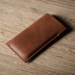 Brown leather  iphone case on a wooden surface
