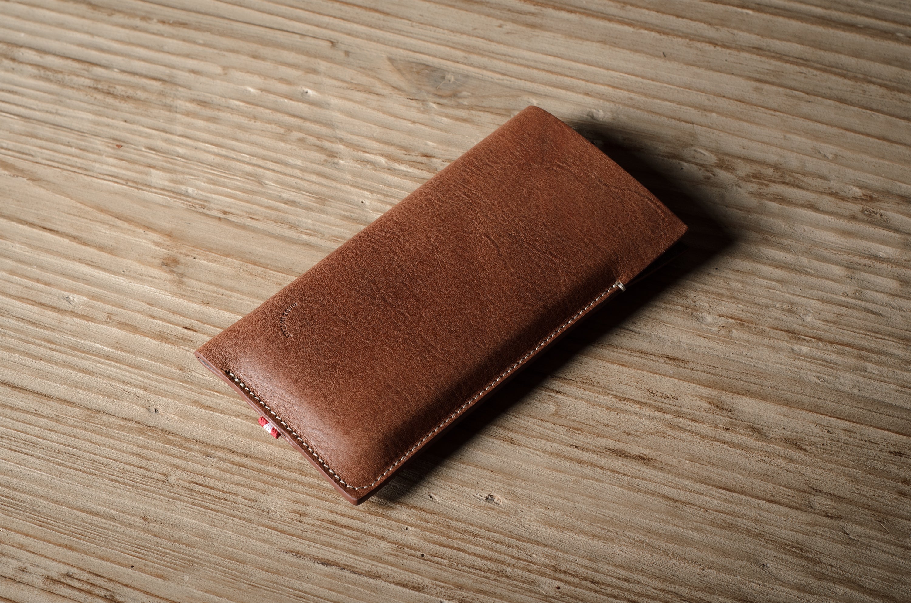Brown leather  iphone case on a wooden surface