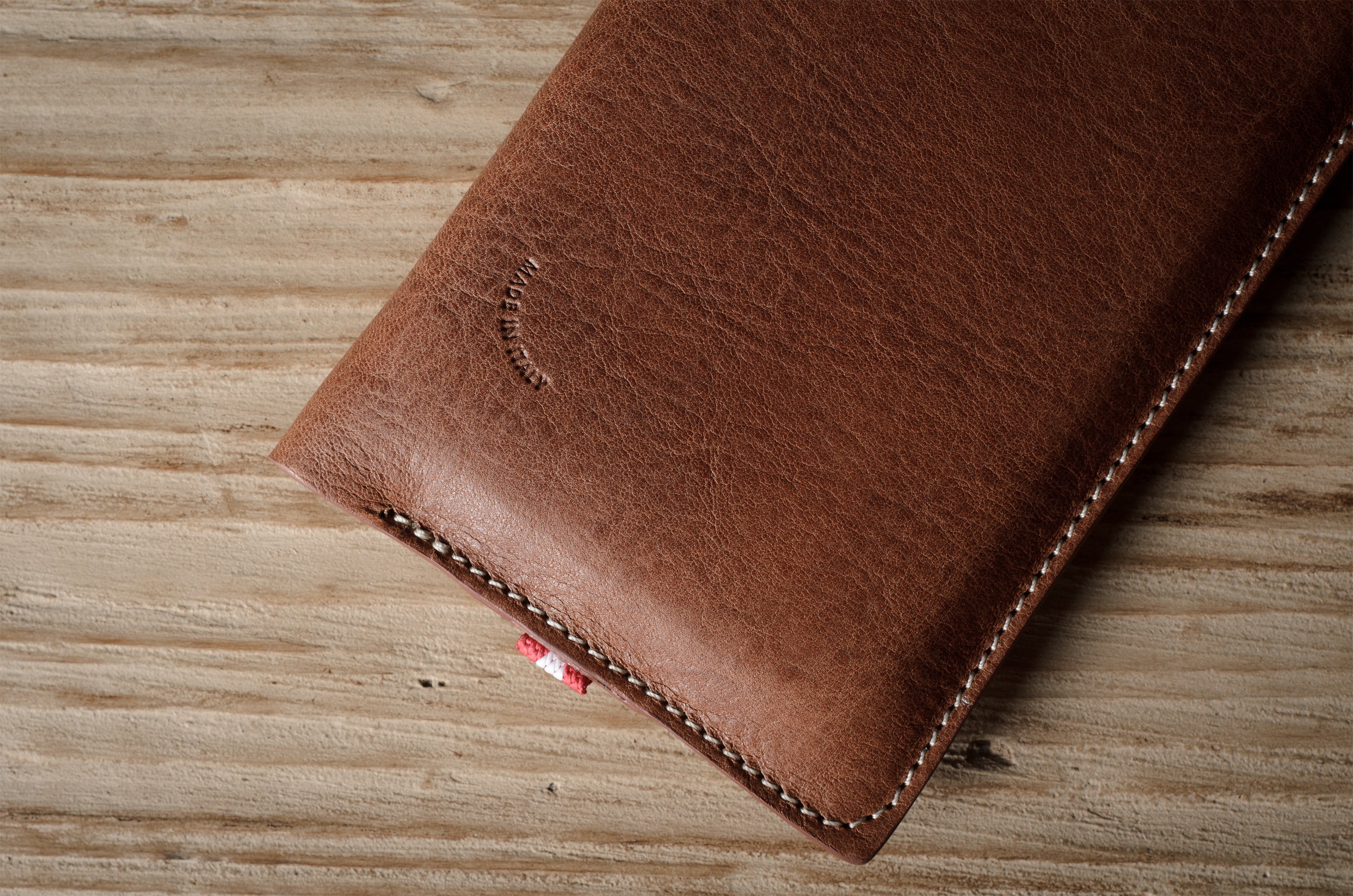 Brown leather iphone case on a wooden surface