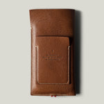 Brown leather  iphone case with brand embossing on a light gray background