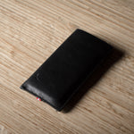 Black iphone case on a wooden surface