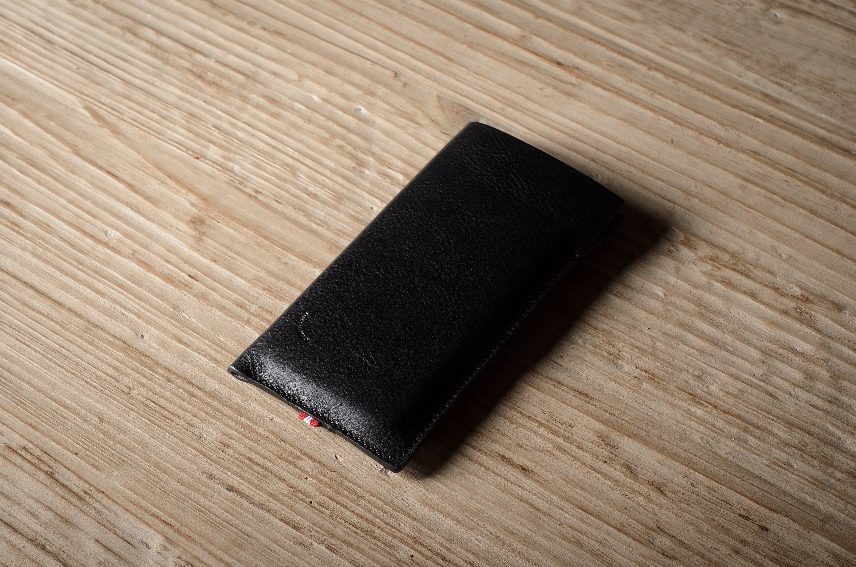 Black iphone case on a wooden surface