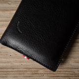 Black leather iphone case on a wooden surface