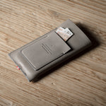 Gray iphone case with cards on a wooden surface