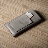 Gray iphone case with cards on a wooden surface