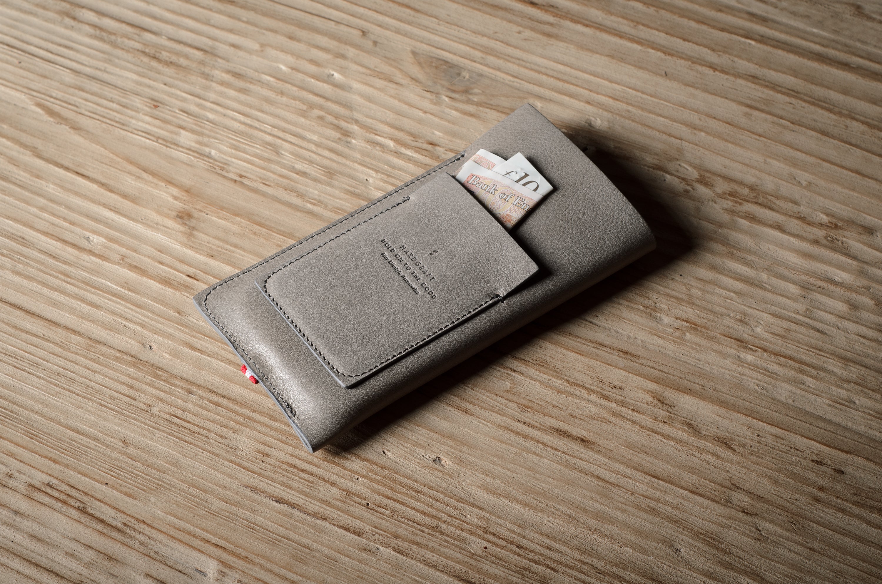 Gray iphone case with cards on a wooden surface