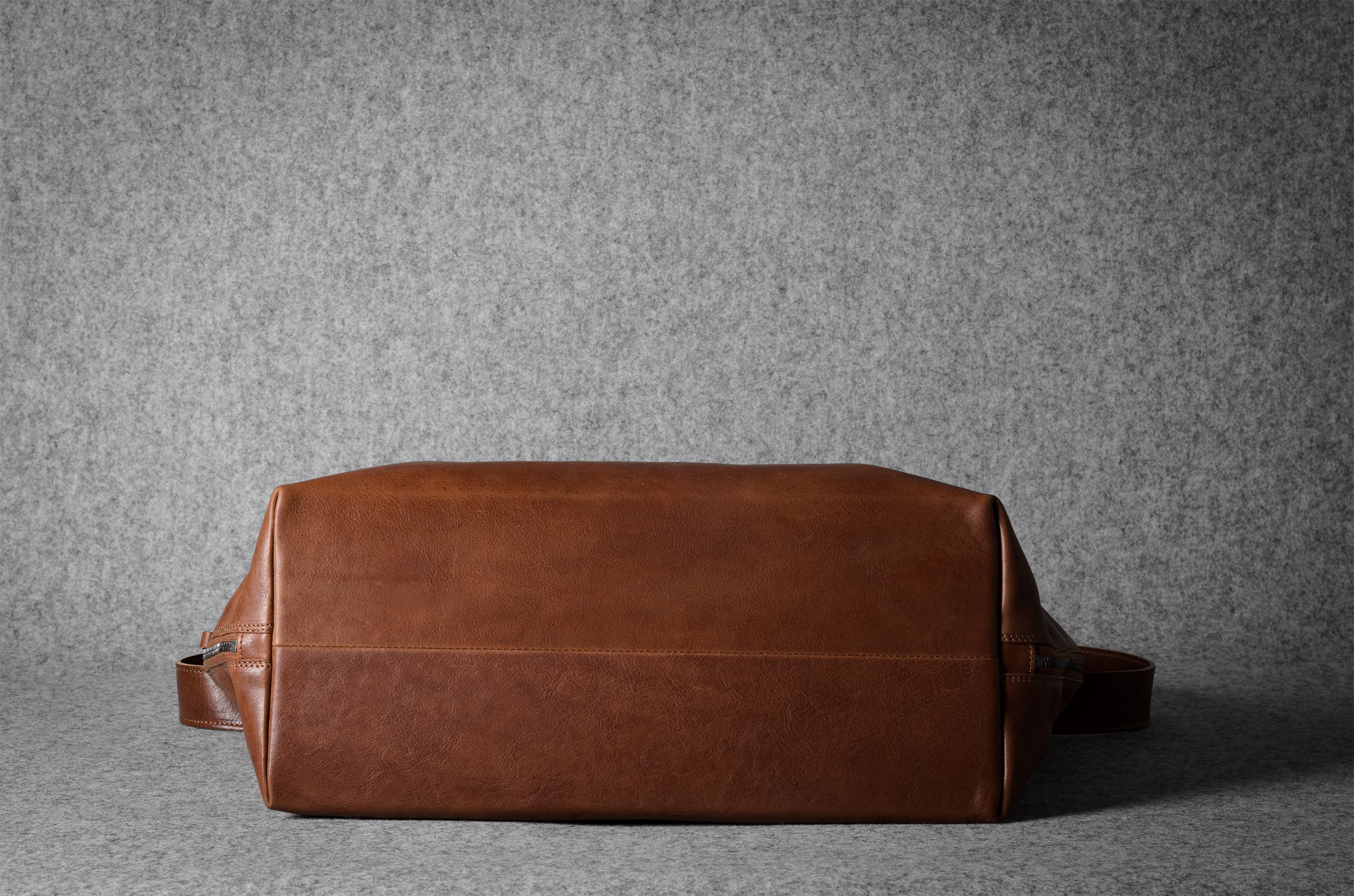 Brown leather bag on a gray background