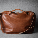 Brown leather bag on a gray background