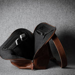 Brown leather bag on a gray background