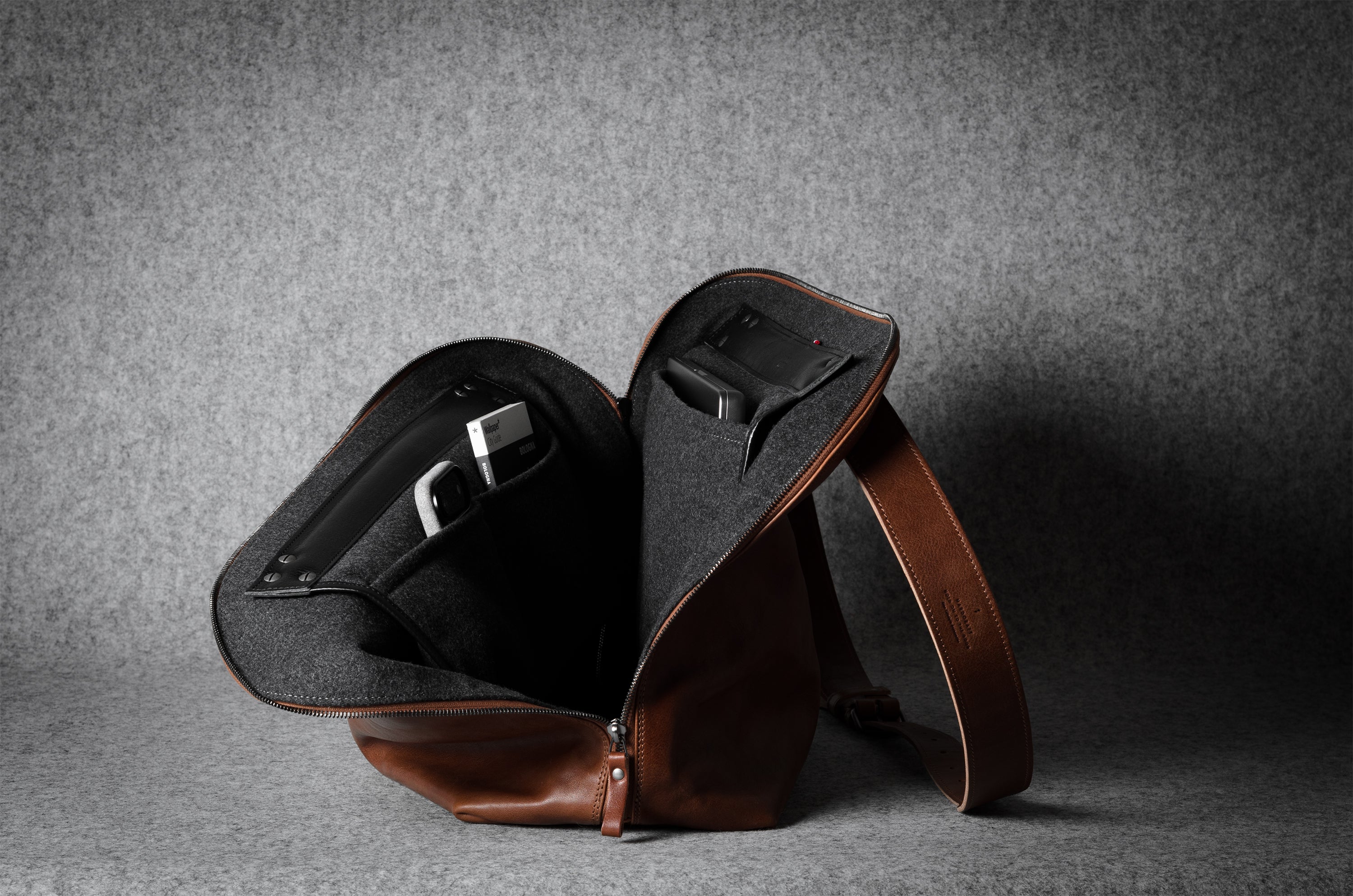 Brown leather bag on a gray background