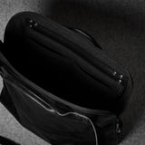 Black bag on a dark textured surface