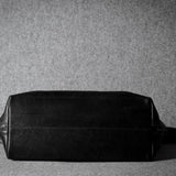 Black leather bag on a gray background