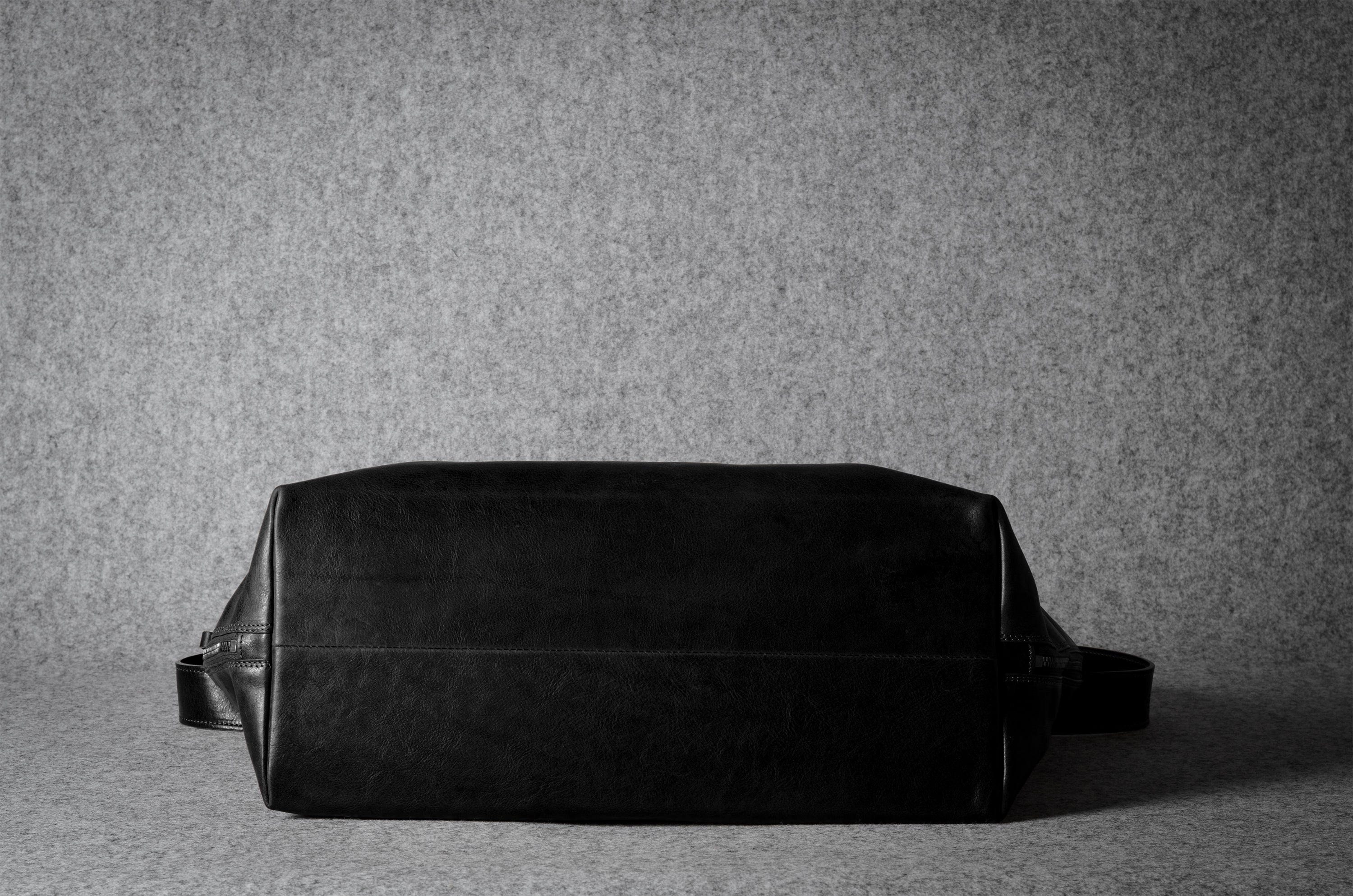 Black leather bag on a gray background