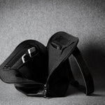 Black leather bag on a gray background