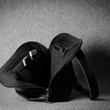 Black leather bag on a gray background