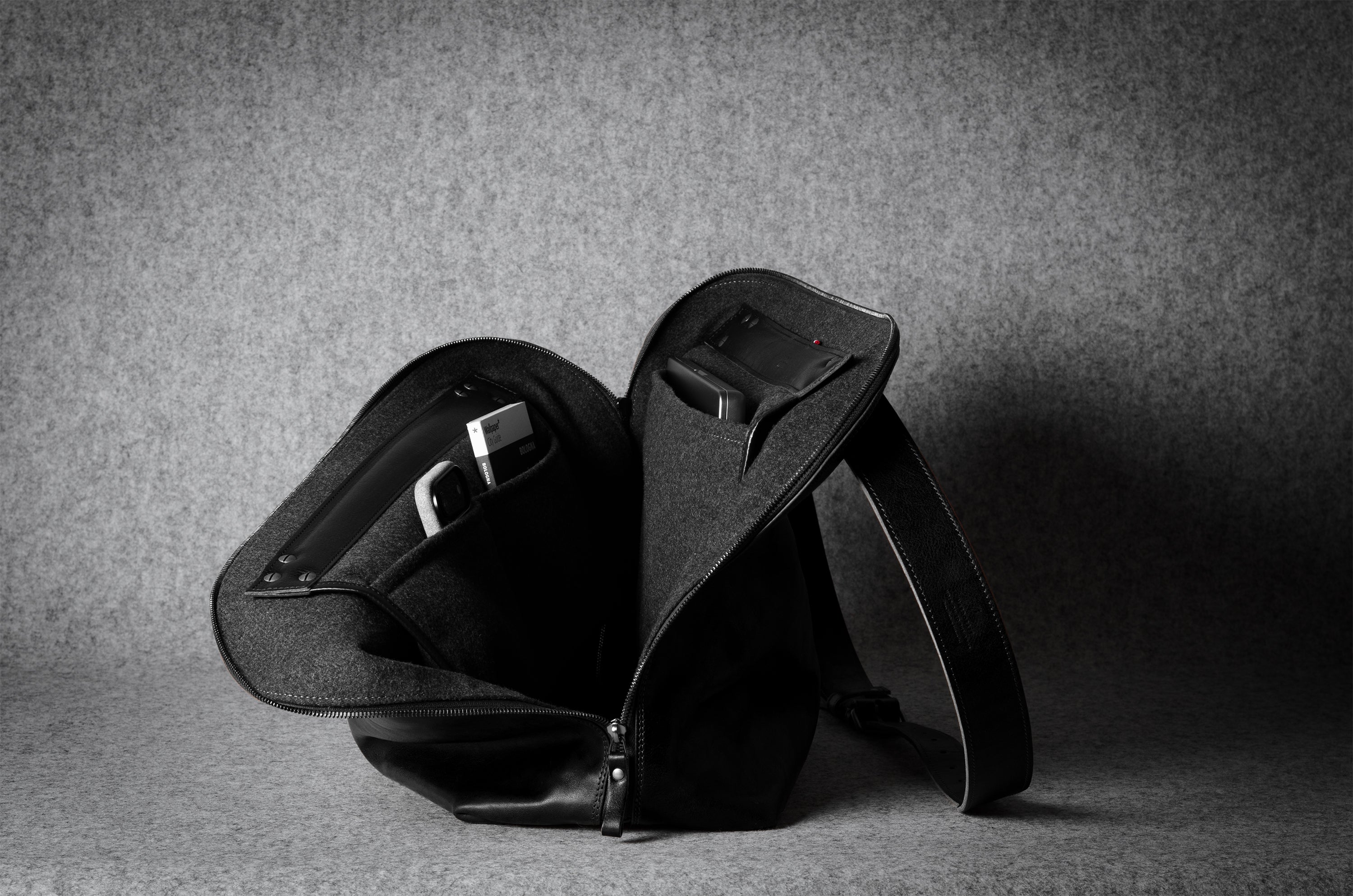 Black leather bag on a gray background