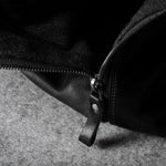 Close-up of a black zipper on a textured surface