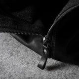 Close-up of a black zipper on a textured surface