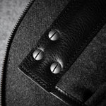 Close-up of a bag interior with a zipper and leather accents.