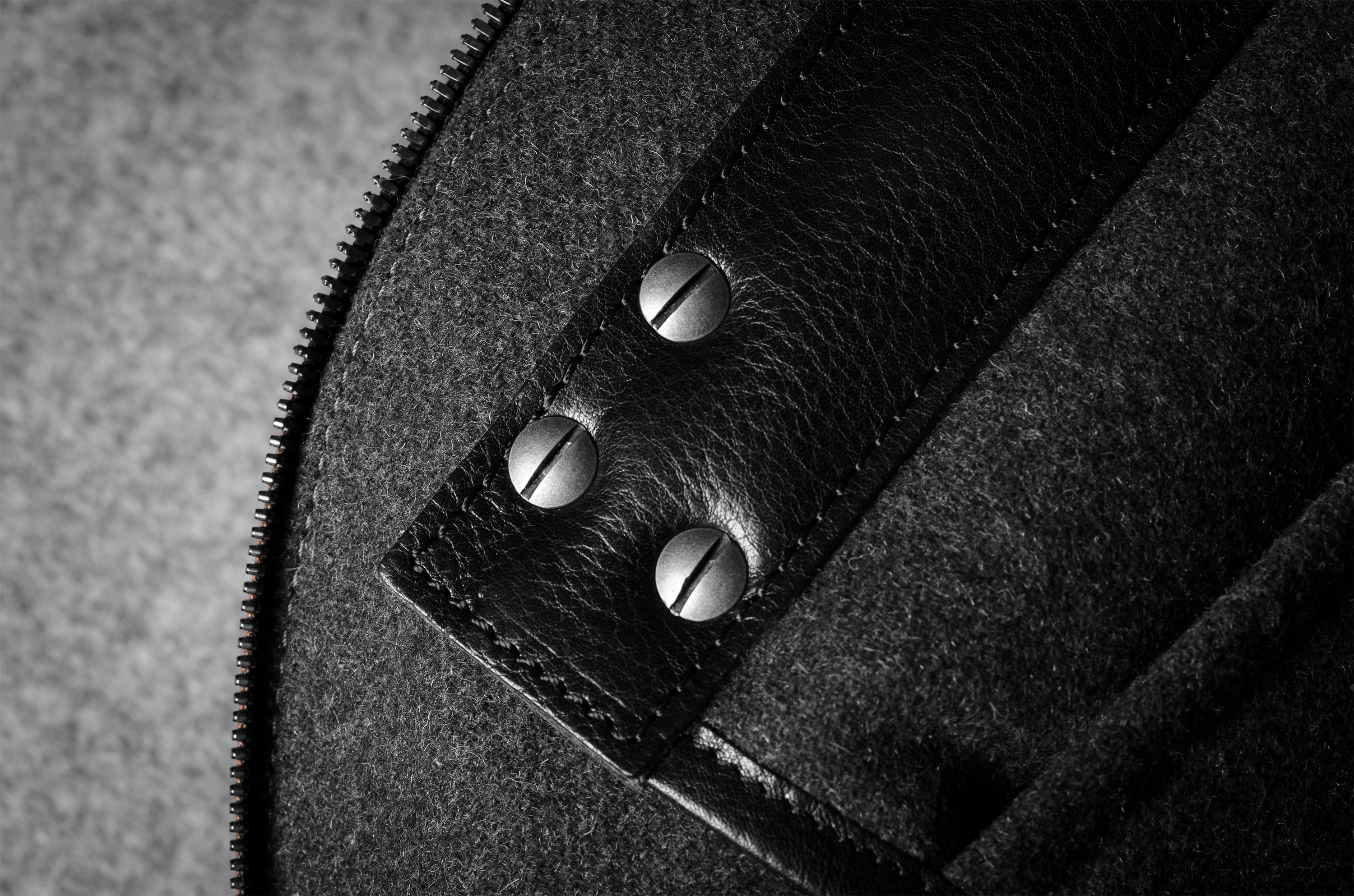 Close-up of a bag interior with a zipper and leather accents.