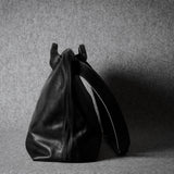 Black leather bag on a gray background