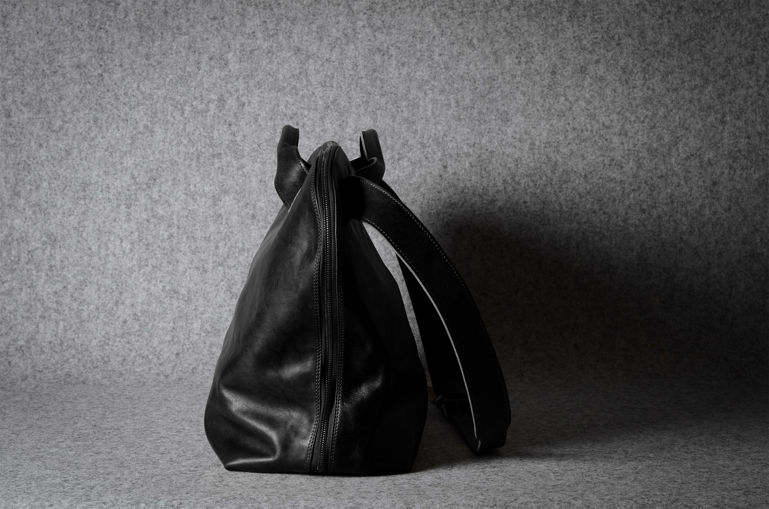 Black leather bag on a gray background