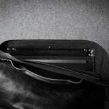 Black leather bag with a textured gray background