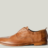 Brown leather dress shoe on a light gray background