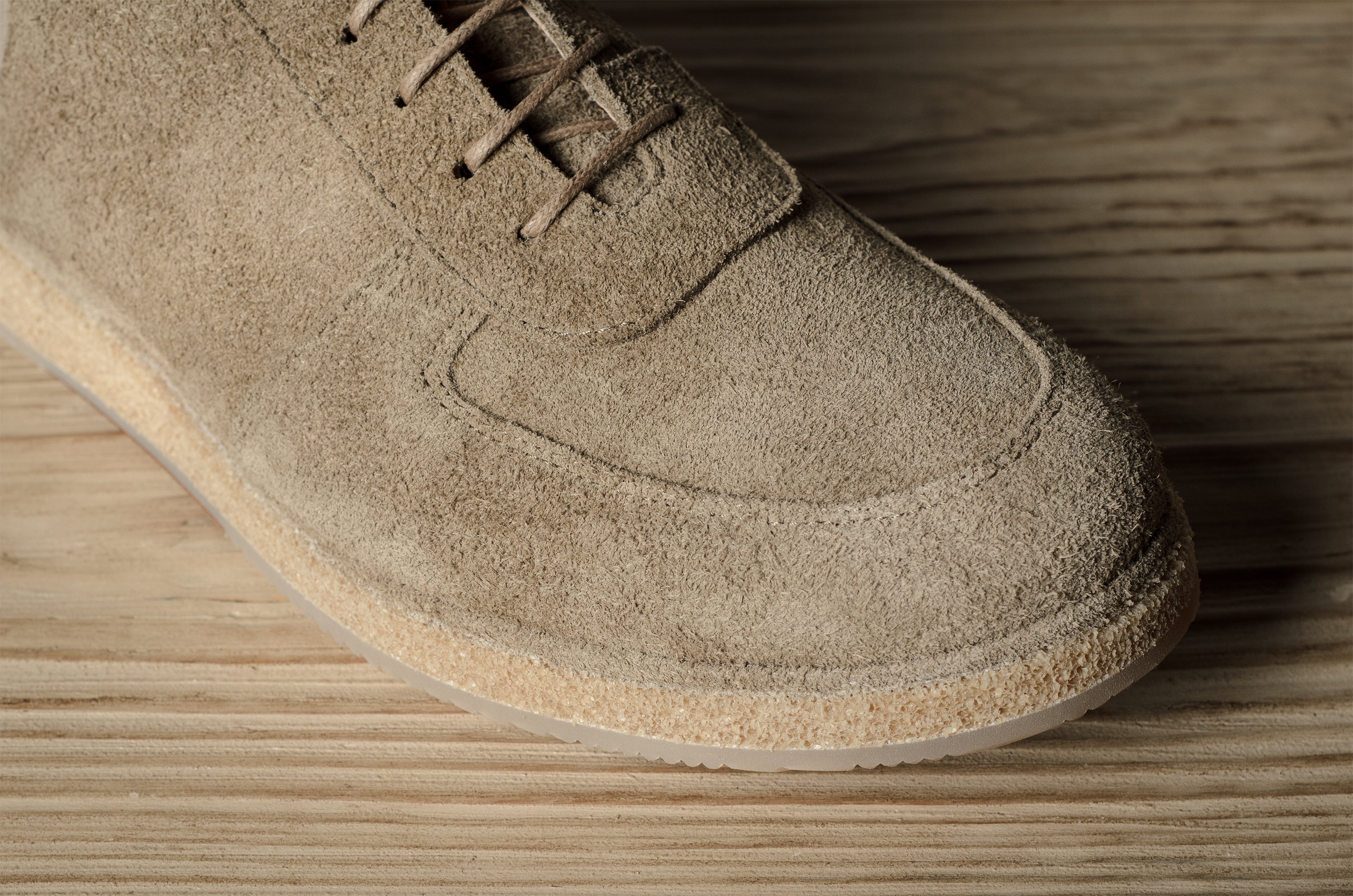 Brown suede shoe on a wooden surface