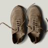 Pair of brown suede shoes on a light gray background