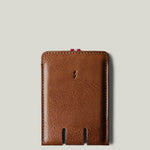 Brown leather card case on a light gray background