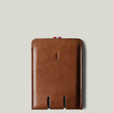 Brown leather card case on a light gray background