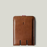 Brown leather card case on a light gray background