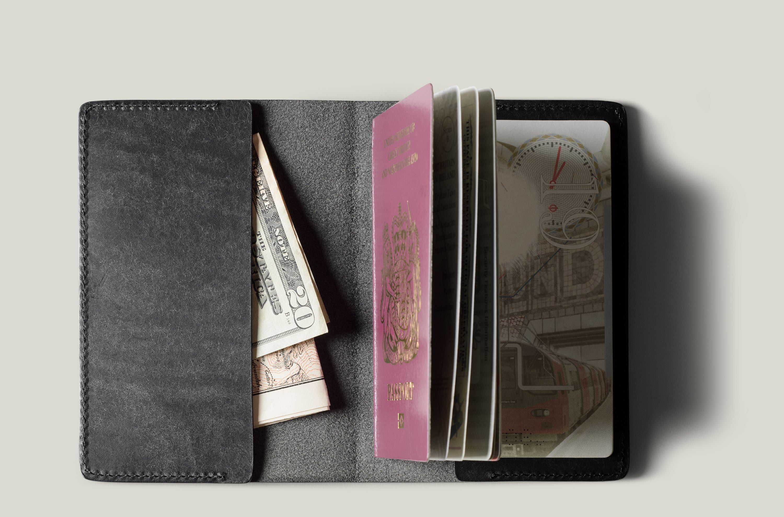 Black passport Case with passport on light background