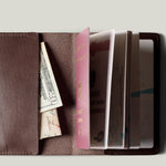 Brown passport Case with passport on light background