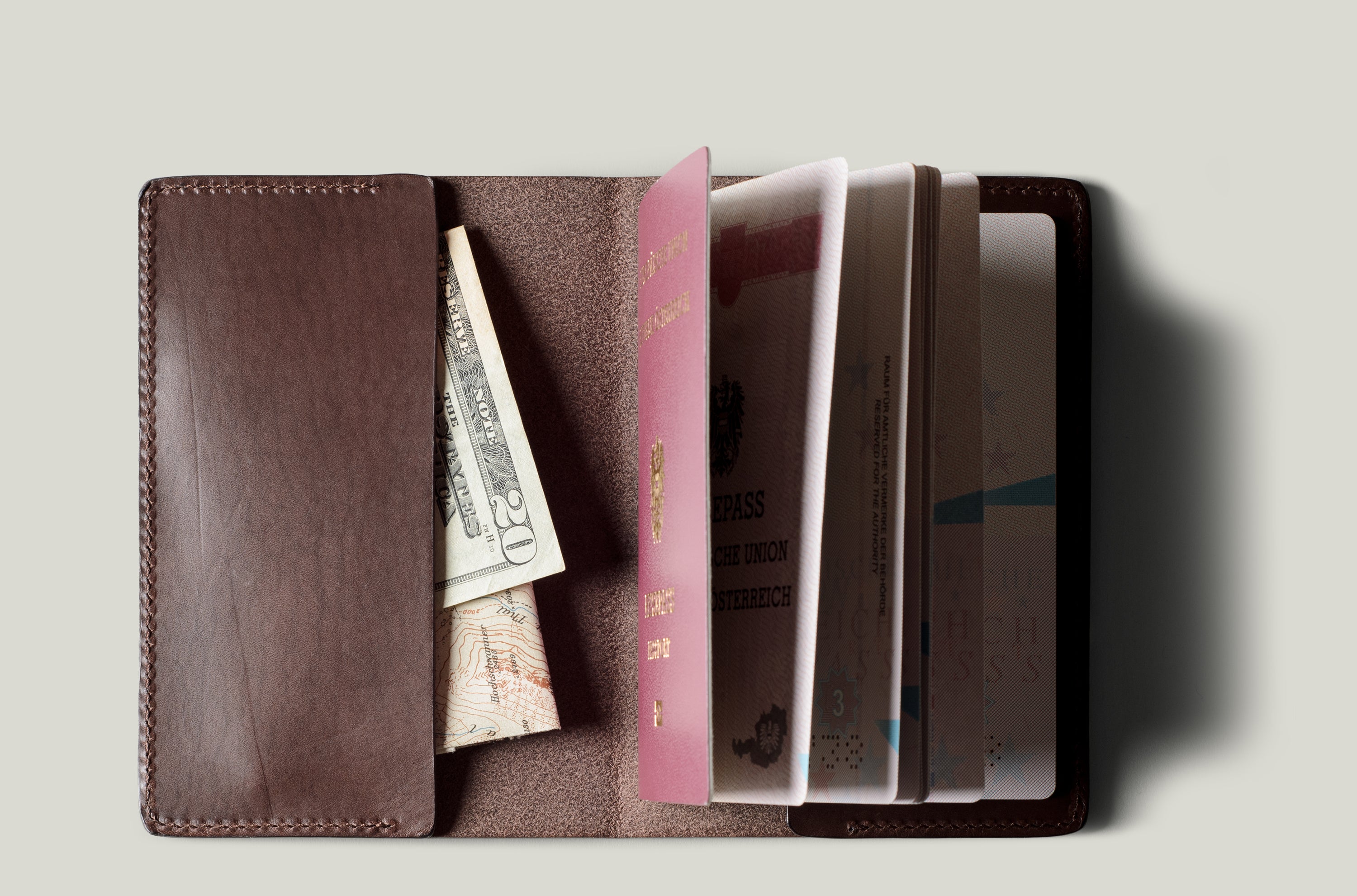 Brown passport Case with passport on light background