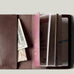 Brown passport Case with passport on light background